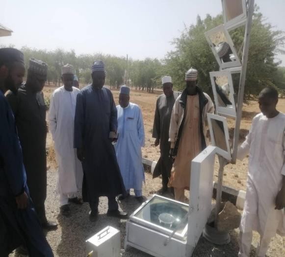 The circular top box solar cooker being demonstrated to visitors at the Centre.