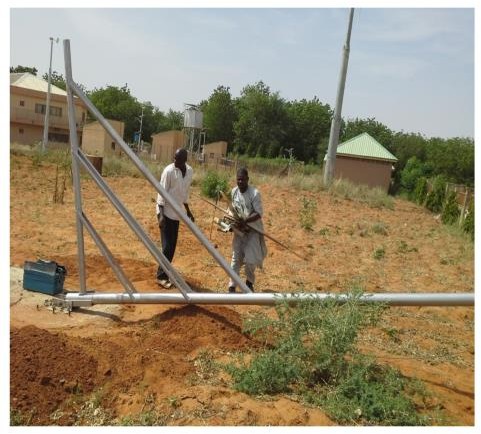 SERC staff erecting a locally fabricated wind turbine tower.